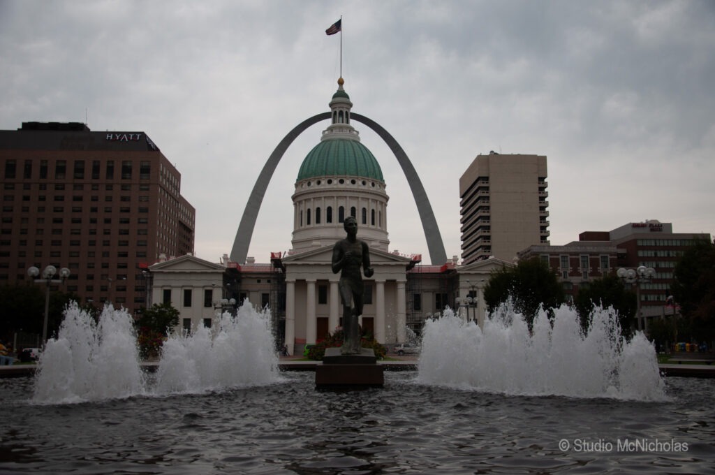 A soaring, sleek monument rises against a cloudy sky, showcasing modern architectural design and symbolizing ambition or progress.
