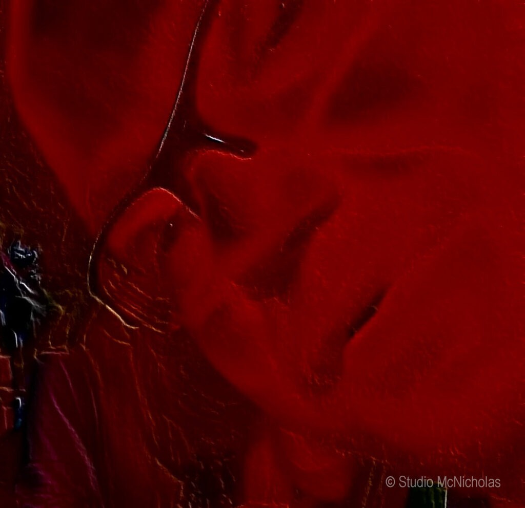 Abstract close-up of a face partially obscured by vivid red fabric, conveying a sense of intimacy and emotion.